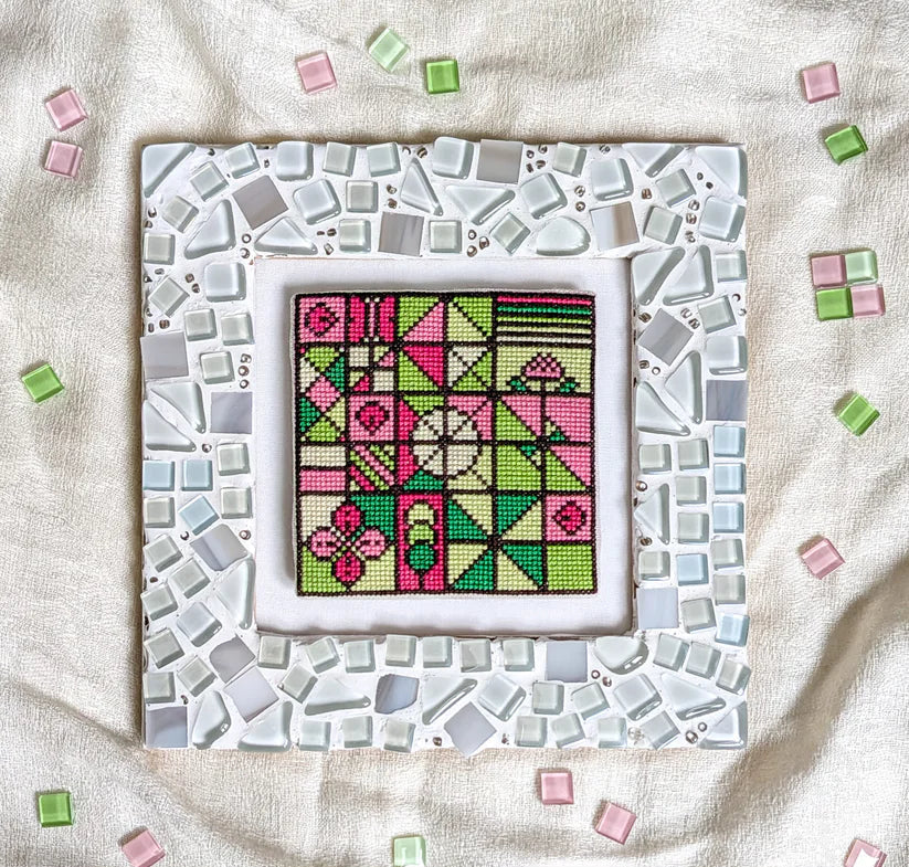 Cross stitch pattern book cover with mosaic design and text