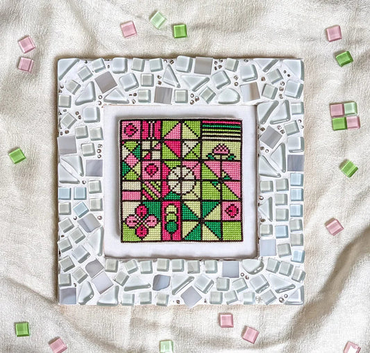 Cross stitch pattern book cover with mosaic design and text