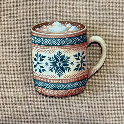 Ceramic mug with decorative patterns on a textured fabric background